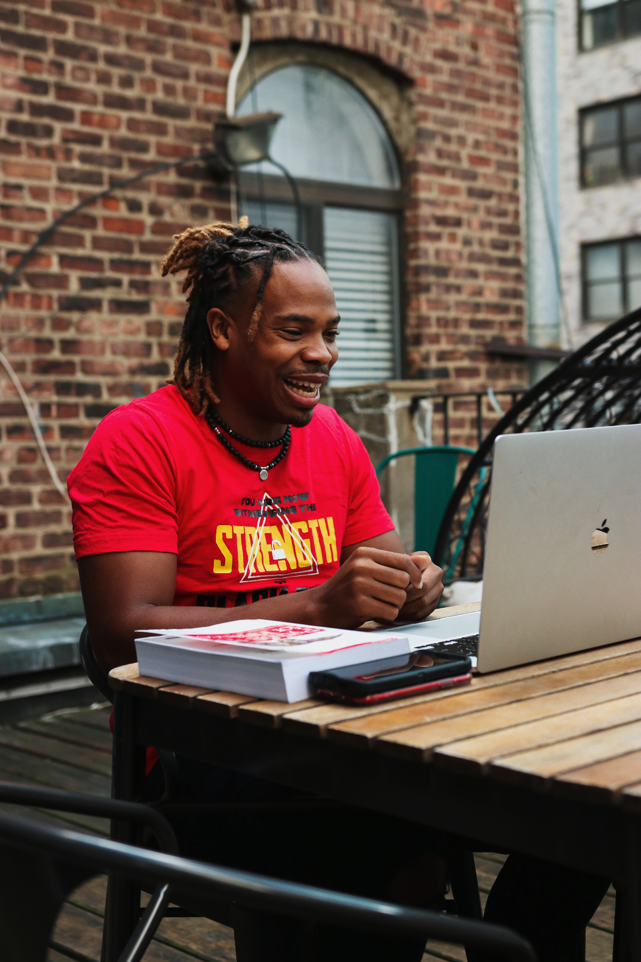 Antoine laughing while teaching at a laptop