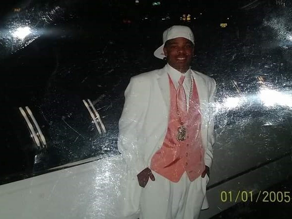 Antoine in a white suit and pink vest on prom night, 2005