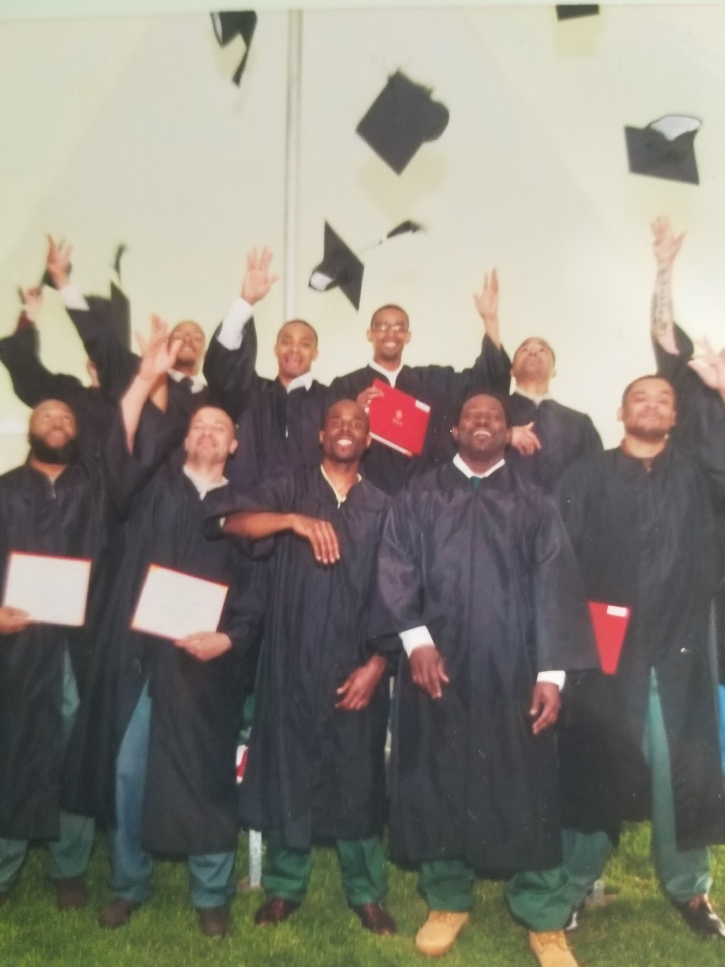 Graduation ceremony inside the prison, caps in the air