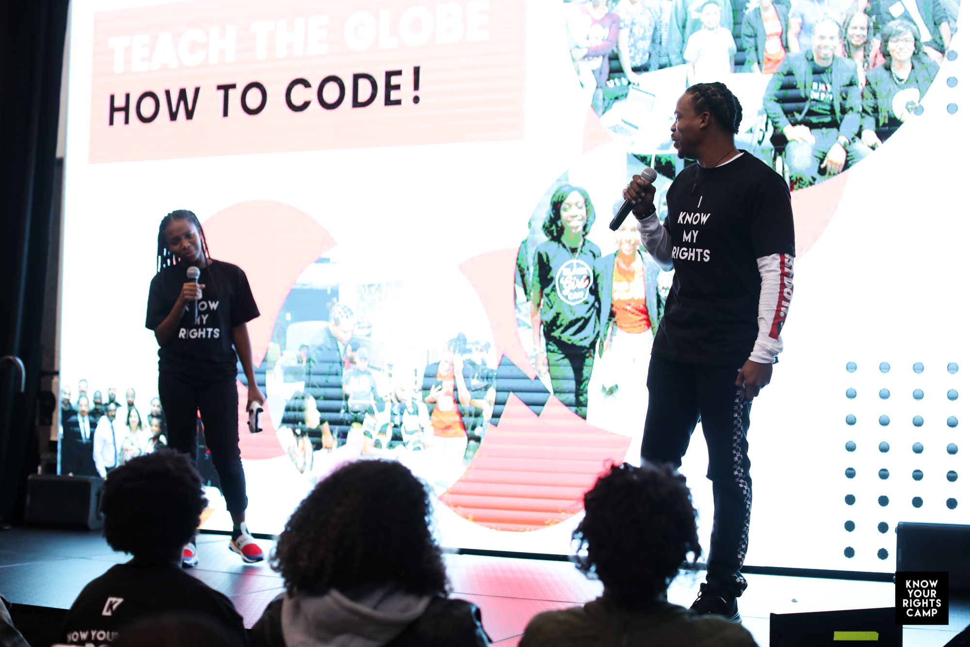 Antoine on stage at Know Your Rights Camp, teaching the globe how to code